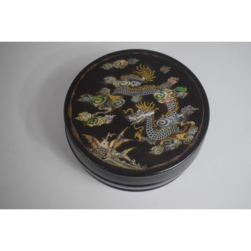 269 - A Chinese Circular Lidded Box with Mother of Pearl Inlay depicting Dragon and Flying Fish, 11cms Dia... 