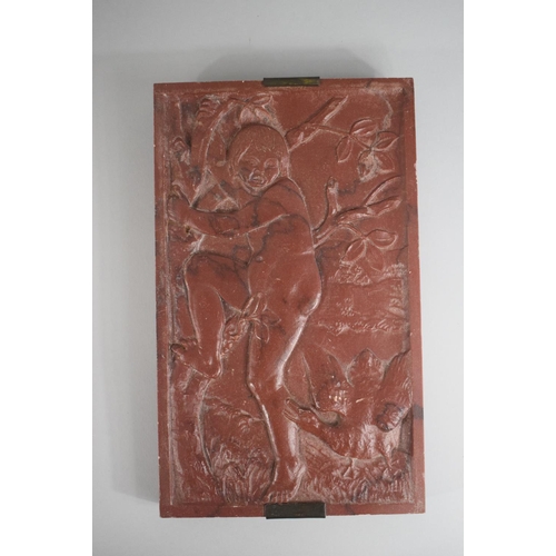 276 - An Interesting Carved Red Marble Plaque depicting Naked Boy Climbing Tree to Escape Goose. 25.5x15cm... 