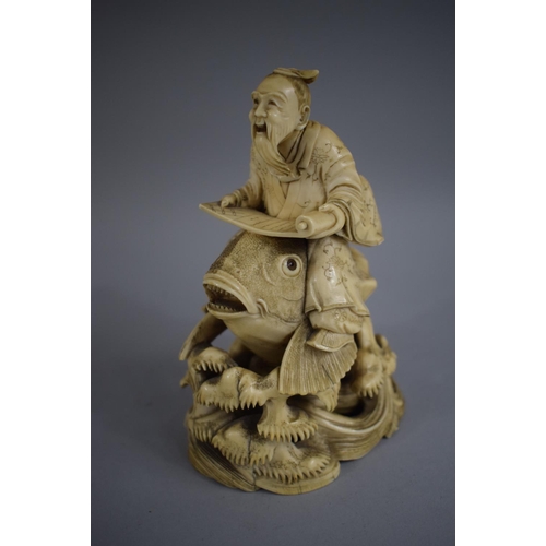 279 - A Signed 19th Century Chinese Ivory Okimono of Elder with Scroll Riding Carp. 15cms High