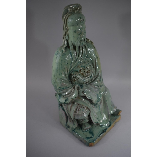 379 - An Early Glazed Chinese Stoneware Figure of Seated Immortal Wearing Robe with Lion Mask Decoration i... 