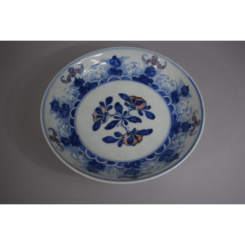 383 - An Oriental Blue and White Bowl decorated with Flowers and Stylised Bats, 20cm Diameter.