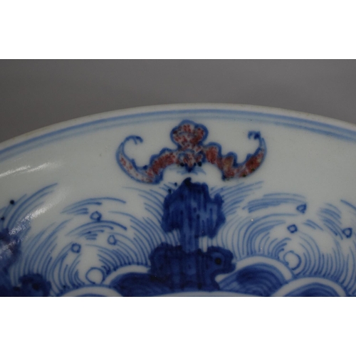 383 - An Oriental Blue and White Bowl decorated with Flowers and Stylised Bats, 20cm Diameter.