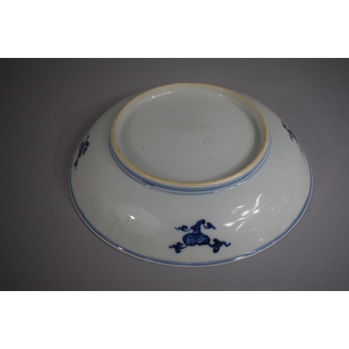 383 - An Oriental Blue and White Bowl decorated with Flowers and Stylised Bats, 20cm Diameter.