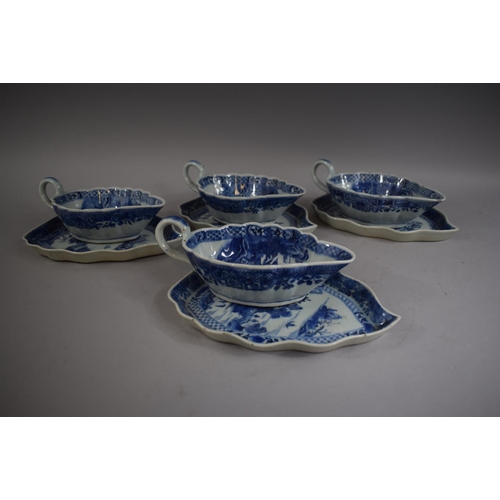 385 - A Set of Four Chinese Blue and White Sauce Boats on Trays decorated with Pagodas and Willow Trees.