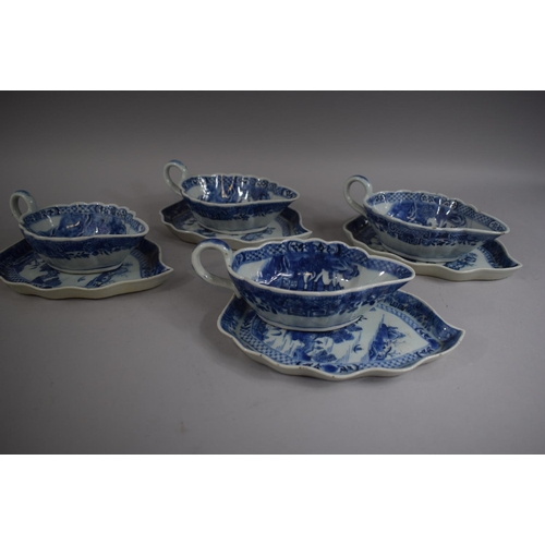 385 - A Set of Four Chinese Blue and White Sauce Boats on Trays decorated with Pagodas and Willow Trees.