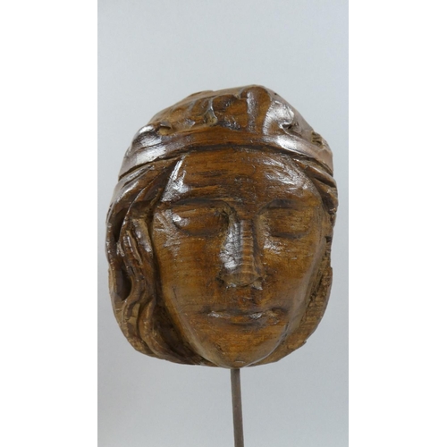 390 - A 19th Century or Earlier Fragment of Church Carving. The Face of a Female Saint mounted on Later Oa... 