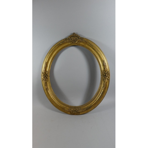 392 - A 19th Century Carved Wood Oval Picture Frame with Original Gilded Decoration. 70x60cms