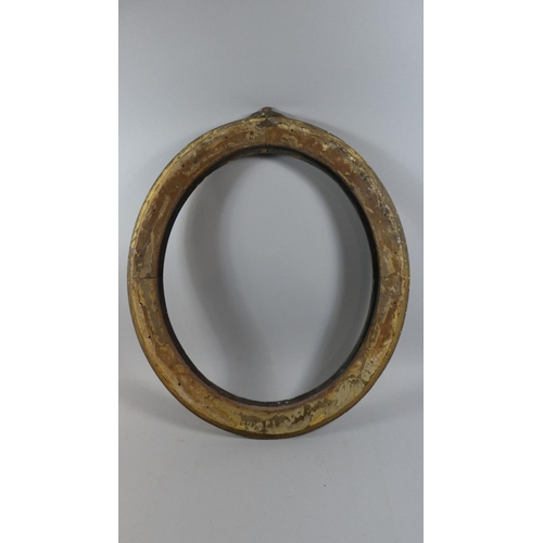 392 - A 19th Century Carved Wood Oval Picture Frame with Original Gilded Decoration. 70x60cms