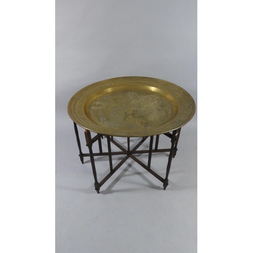 432 - An African Circular Brass Marriage Table with Folding Stand decorated in Relief with Coconut Palm, G... 