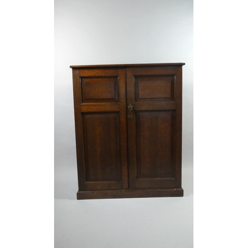 433 - An Edwardian Oak Shelved Side Cabinet with Panelled Doors and Plinth Base. 93x40x114cms