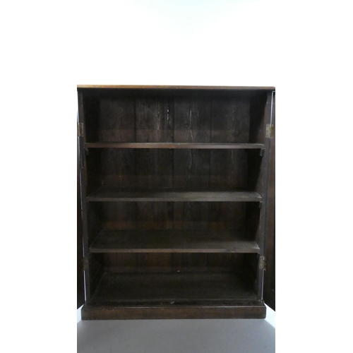 433 - An Edwardian Oak Shelved Side Cabinet with Panelled Doors and Plinth Base. 93x40x114cms