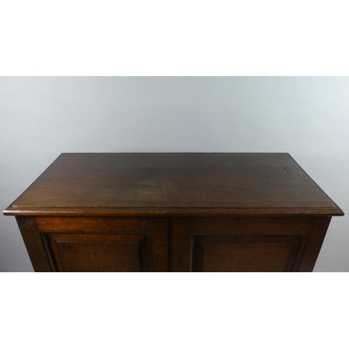 433 - An Edwardian Oak Shelved Side Cabinet with Panelled Doors and Plinth Base. 93x40x114cms