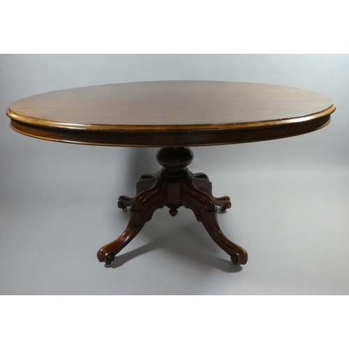 438 - A Late Victorian Mahogany Oval Snap Top Breakfast Table on Four Scrolled Supports. 134x103cms