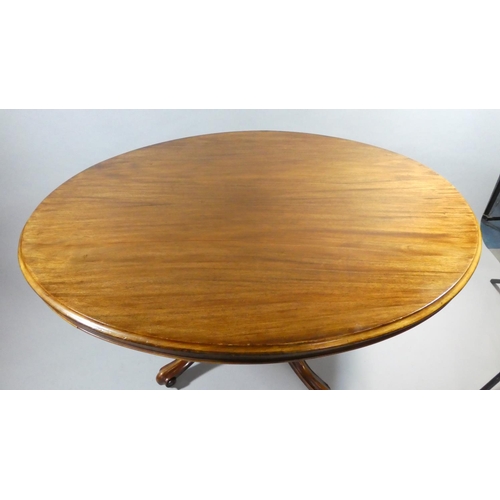 438 - A Late Victorian Mahogany Oval Snap Top Breakfast Table on Four Scrolled Supports. 134x103cms