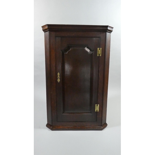 443 - A 19th Century Oak Hanging Corner Cabinet with Panelled Door with Brass H Hinges to Shelved Interior... 