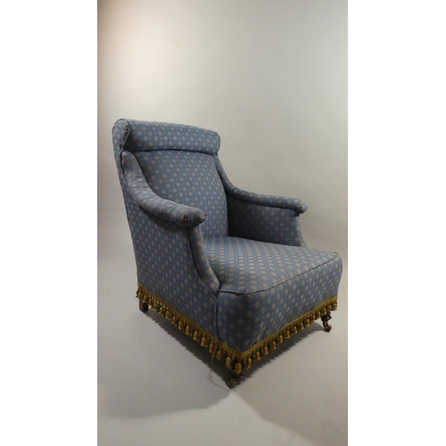 445 - An Edwardian Upholstered Armchair on Brass Castors to Front Legs.