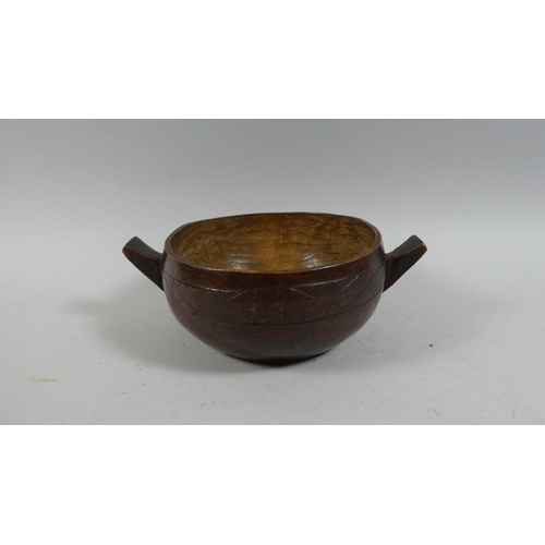 62 - An Early 20th Century Carved Scandinavian Two Handled Bowl with Chip Carved Decoration. 23cms Wide