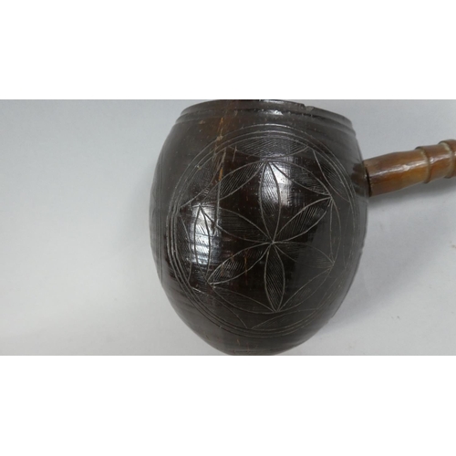 63 - A Mid 19th Century Sailor Made Water Dipper. The Bowl made from a carved Coconut Shell with a carved... 