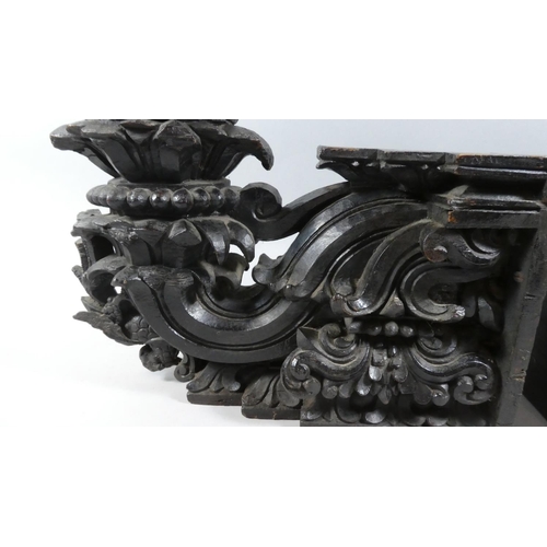 71 - A Pair of 19th Century Indian Carved Wood and Ebonised Candle Sconce Brackets. 36x15x32cms