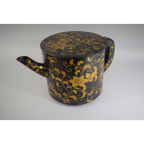 73 - A Good Japanese Lacquer Teapot with Gilt Floriate Decoration of Circular Form on Three Feet. 19cms H... 