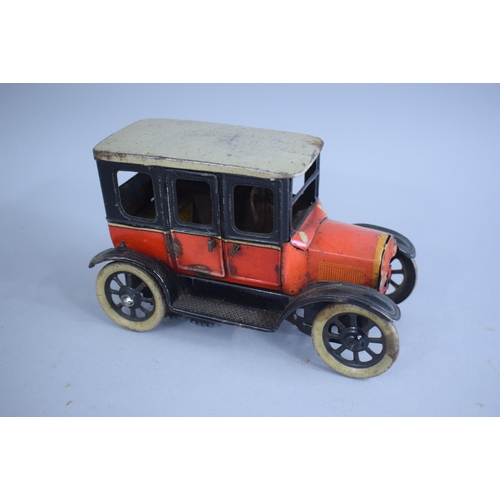 127 - A 1920s German Tin Plate Clockwork Model of a Ford Tudor Saloon, Paper Label Under. 15.5cms Wide x10... 