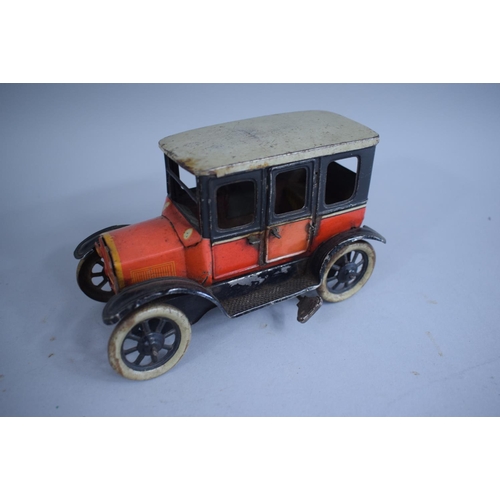 127 - A 1920s German Tin Plate Clockwork Model of a Ford Tudor Saloon, Paper Label Under. 15.5cms Wide x10... 