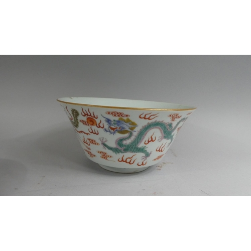 381 - A Chinese Bowl decorated in Multicoloured Enamels depicting Dragons Chasing Flaming Pearls. Chip to ... 