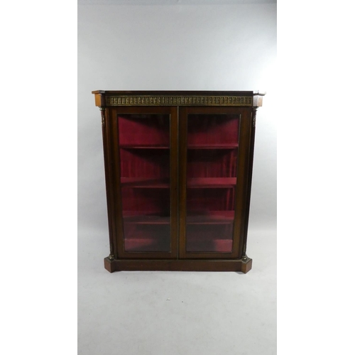 80 - A French Ormolu Mounted Mahogany Glazed Bookcase on Canted Plinth Base. 107cms Wide