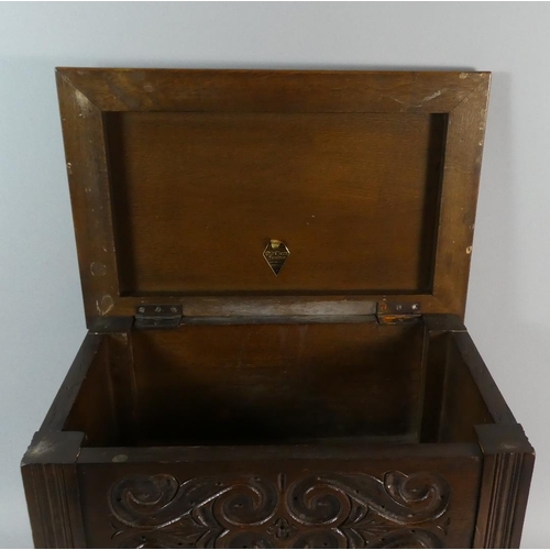 7 - An Old Charm Oak Lift Top Sewing Box with Carved Panels, 44cms Wide