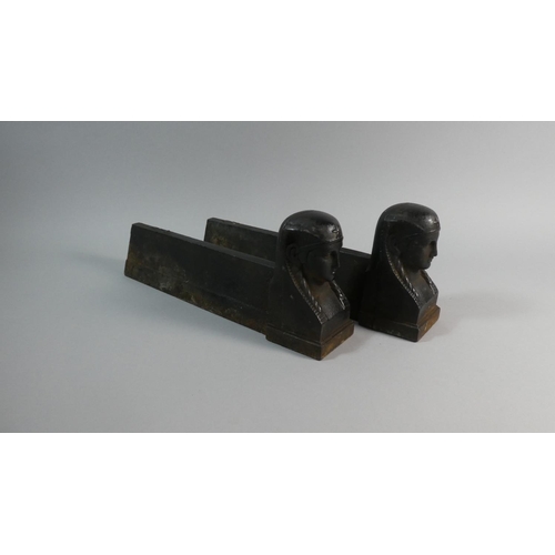 63 - A Pair of 19th Century French Cast Iron Fire Dogs Modelled as Sphinx Heads. 34cms Long