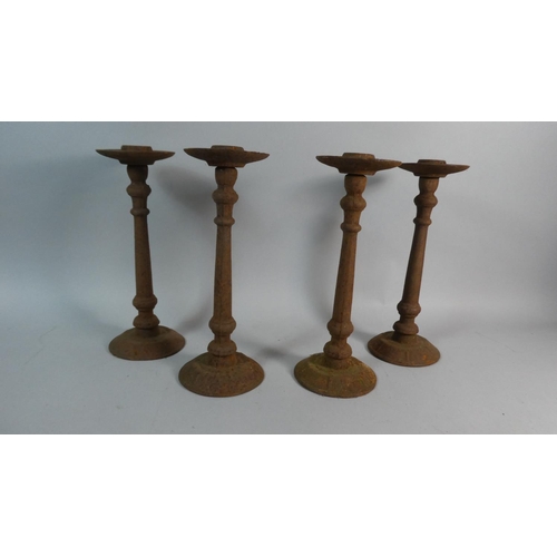 62 - A Set of Four Continental Cast Iron Church Candlesticks, 30cms High