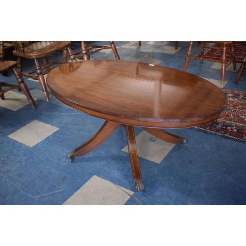 419 - A Good Quality Oval Crossbanded Snap Top Coffee Table by Lawrences of Shrewsbury, Claw Feet and Cast... 