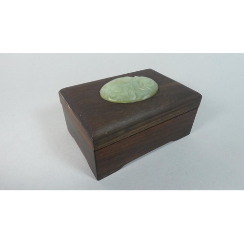 12 - An Oriental Rectangular Box with Carved Jade Oval Mount, 13cm WIde