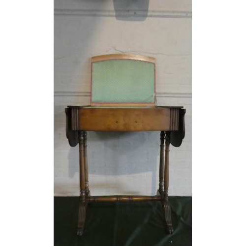 32 - An Edwardian Walnut Drop Leaf Lift Top Sewing Table with Turned Supports and Green Upholstered Inter... 