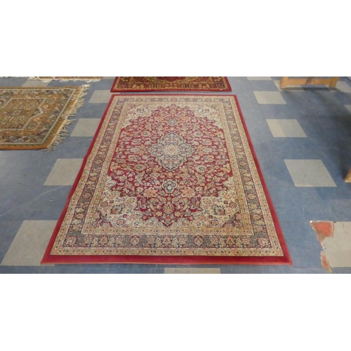 462 - A Belgian Samarkand Patterned Rug on Red Ground 198cm x 137cm