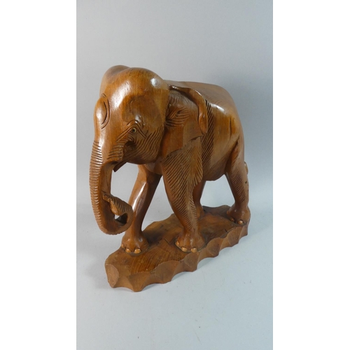 55 - A Carved Wooden Study of an Indian Elephant, 37cm High