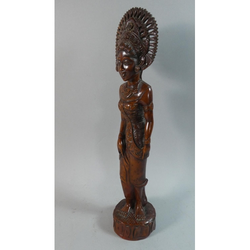 59 - A Carved Thai Wooden Figure of a Maiden, 43cm high