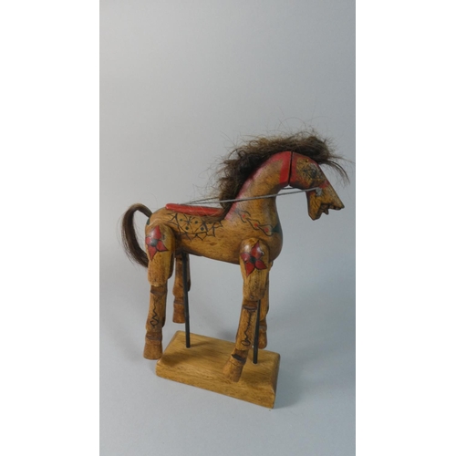 62 - A Vintage Carved Wooden Toy Horse with Articulated Legs Set on Stand, 29cm High