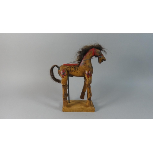 62 - A Vintage Carved Wooden Toy Horse with Articulated Legs Set on Stand, 29cm High