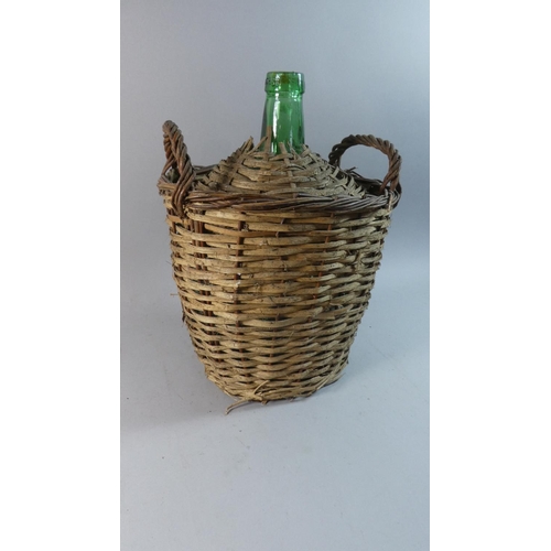 70 - A Wicker Covered Green Glass Bottle, 38cm High