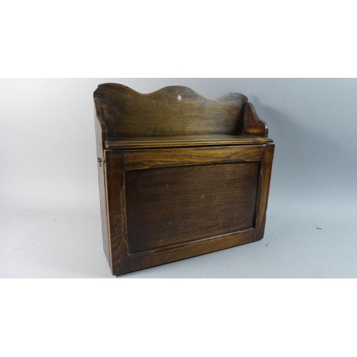 73 - An Edwardian Oak Wall Hanging Sectioned Shelf Unit with Pull Down Front, 38cm Wide