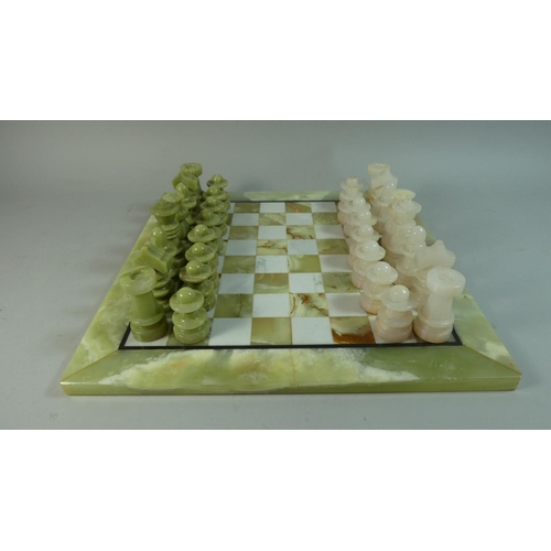 87 - A Mid/Late 20th Century Onyx Chess Board and Complete Set of Chess Pieces, 41cm Square