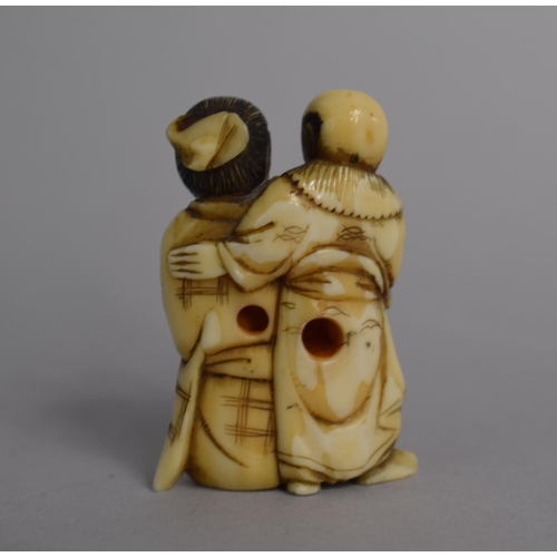 218 - A 19th Century Oriental Ivory Netsuke in the Form of Farmers with Sack, 4.5cm high