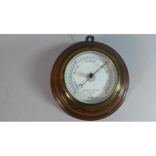 21 - An Edwardian Circular Oak Framed Aneroid Barometer by Negretti & Zambra, No.5366