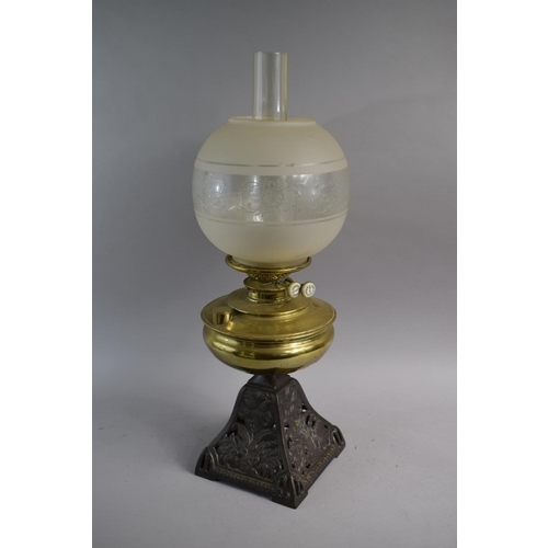 111 - A Late Victorian Pierced Iron Oil Lamp with Brass Reservoir, Chimney and Shade