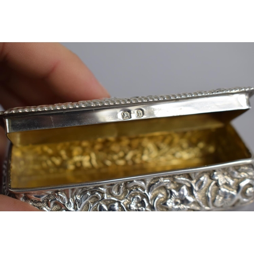 155 - A Small Rectangular Silver Dressing Table Box with Repousse Decoration, 9cms Wide, 50gms