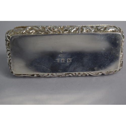 155 - A Small Rectangular Silver Dressing Table Box with Repousse Decoration, 9cms Wide, 50gms