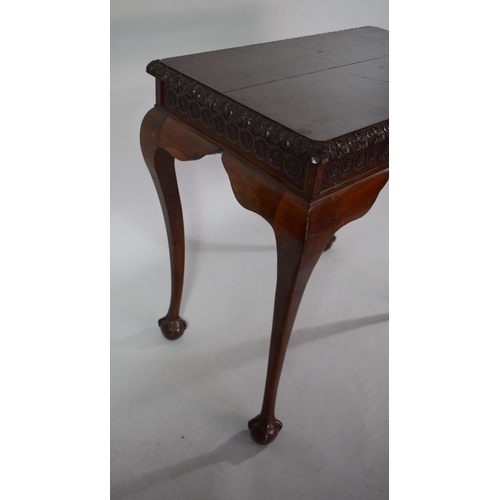 34 - A Mahogany Silver Table with Carved Border set on Cabriole Legs culminating in Claw and Ball Feet/ 8... 