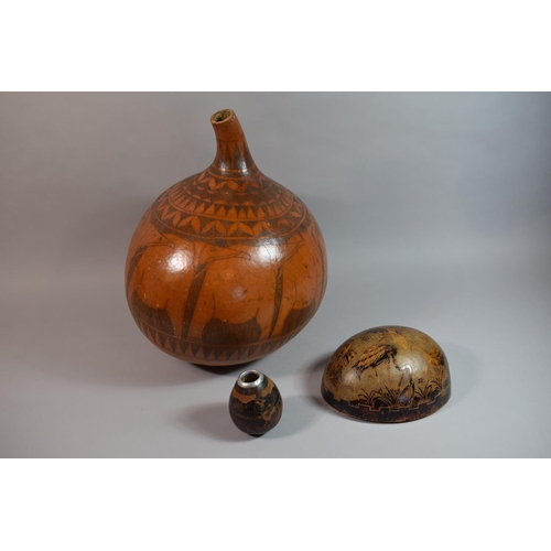 69 - A Collection of Three South American Carved Gourds, The Largest 38cm high