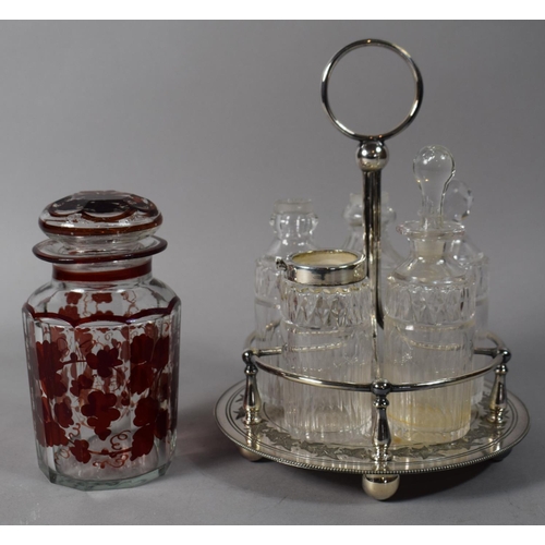 120 - A Silver Plated Five Bottle Cruet and an Overlaid Glass Jar